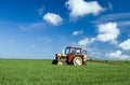 Tractor spraying green field