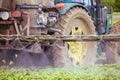 Tractor spraying pesticide, pesticides or insecticide spray on lettuce or iceberg field Pesticides and insecticides on Royalty Free Stock Photo