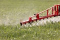 Tractor spraying pesticides wheat field Royalty Free Stock Photo