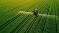 Tractor spraying pesticides at soy bean field. Royalty Free Stock Photo