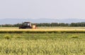 Tractor spraying pesticides at soy bean field Royalty Free Stock Photo