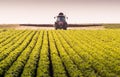 Tractor spraying pesticides on soybean field with sprayer at spring Royalty Free Stock Photo