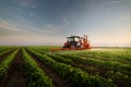 Tractor spraying soybean field