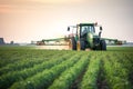 Tractor spraying pesticides on soybean field with sprayer at sunset. Generative AI Royalty Free Stock Photo