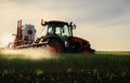 Tractor spraying pesticides wheat field Royalty Free Stock Photo