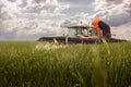 Tractor spraying pesticides wheat field Royalty Free Stock Photo