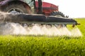 Tractor spraying pesticides wheat field Royalty Free Stock Photo