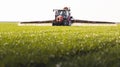 Tractor spraying pesticides wheat field Royalty Free Stock Photo