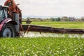 Tractor spraying pesticides wheat field Royalty Free Stock Photo