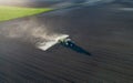 Tractor spraying soil in field Royalty Free Stock Photo