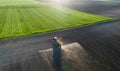 Tractor spraying soil in field Royalty Free Stock Photo