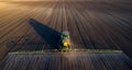 Tractor spraying soil in field Royalty Free Stock Photo