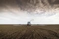 Tractor spraying soil in field Royalty Free Stock Photo