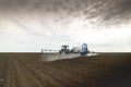 Tractor spraying soil in field Royalty Free Stock Photo