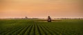 Tractor spraying soybean crops field Royalty Free Stock Photo