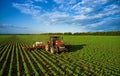 Tractor sprays the field with chemicals to protect the plants. Treatment of agricultural crops against pests. Plant