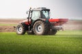 Tractor spreading artificial fertilizers Royalty Free Stock Photo