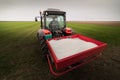 Tractor spreading artificial fertilizers Royalty Free Stock Photo