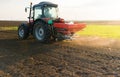 Tractor spreading artificial fertilizers Royalty Free Stock Photo