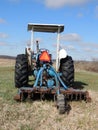 Tractor in Spring field with slow moving vehicle e Royalty Free Stock Photo