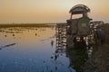 Tractor at sunset on the water Royalty Free Stock Photo