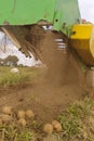 Tractor with suspended equipment for potato harvesting, organically grown potatoes without chemicals. Royalty Free Stock Photo