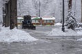 Tractor is sweeping snow in snowfall