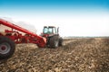 Tractor with tanks in the field. Agricultural machinery and farming. Royalty Free Stock Photo