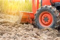 Tractor tire on field. Agriculture Tractor plowing field.