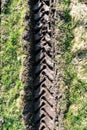 Tractor tire tracks in green grass Royalty Free Stock Photo