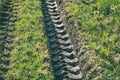 Tractor tire tracks in green grass - vintage retro look Royalty Free Stock Photo