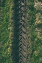 Tractor tire tracks in green grass - vintage retro look Royalty Free Stock Photo