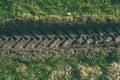 Tractor tire tracks in green grass - vintage retro look Royalty Free Stock Photo