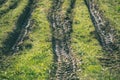 Tractor tire tracks in green grass - vintage retro look Royalty Free Stock Photo