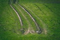 Tractor tire tracks in green grass - vintage retro look Royalty Free Stock Photo