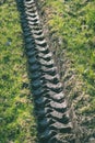 Tractor tire tracks in green grass - vintage retro look Royalty Free Stock Photo