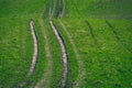 Tractor tire tracks in green grass - vintage retro look Royalty Free Stock Photo