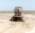 Tractor to level the ground for the road