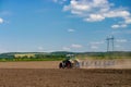 Tractor with a towed plow cultivates the plowing of the field before the autumn sowing