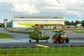 The tractor towing old military helicopter aviation museum exhibit through the airport territory Royalty Free Stock Photo