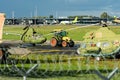 The tractor towing old military helicopter aviation museum exhibit through the airport territory