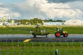 The tractor towing old military helicopter aviation museum exhibit through the airport territory