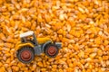 Tractor toy over harvested corn seed Royalty Free Stock Photo