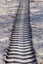 Tractor traces in ground, track of a tractor on a bare soil, footprint of a car on dirt or mud