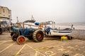 Tractor and traditional crab fishing boat parked up on Cromer beach
