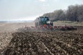 Tractor with trailed planter on the field