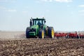 Tractor with trailed planter on the field