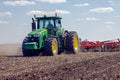 Tractor with trailed planter on the field