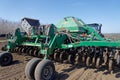 Tractor with trailed seeder on the field