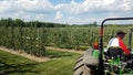 Tractor with a trailer in apple farm Royalty Free Stock Photo